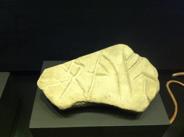 A stone with Viking rune carvings inscribed.